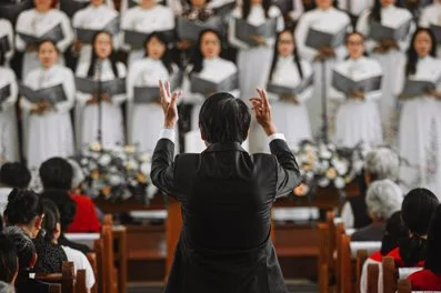 Where do the best singers in a choir stand?