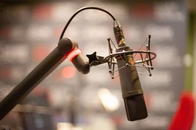 Why do people hang condenser mics upside down?